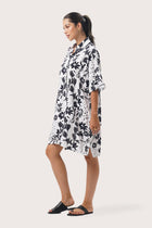 Side profile of the Lupita Midi Dress White showing its cut and natural movement