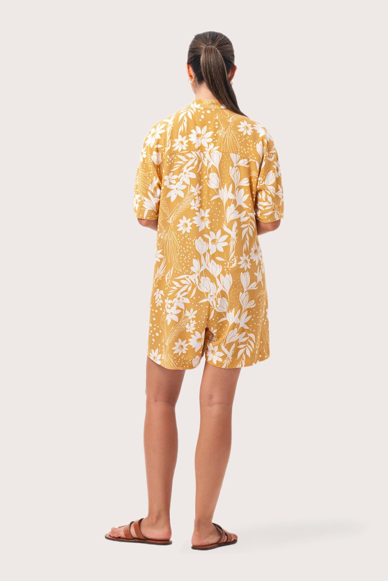 Back view of the Lupita Midi Dress Yellow highlighting the garment shape and drape