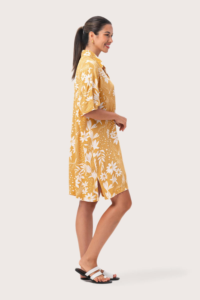 Side profile of the yellow Lupita midi dress showcasing its relaxed silhouette