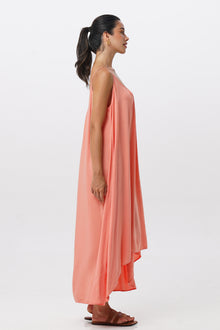 Side profile of the Mala Lowback Maxi Dress Rosa showing its cut and natural movement