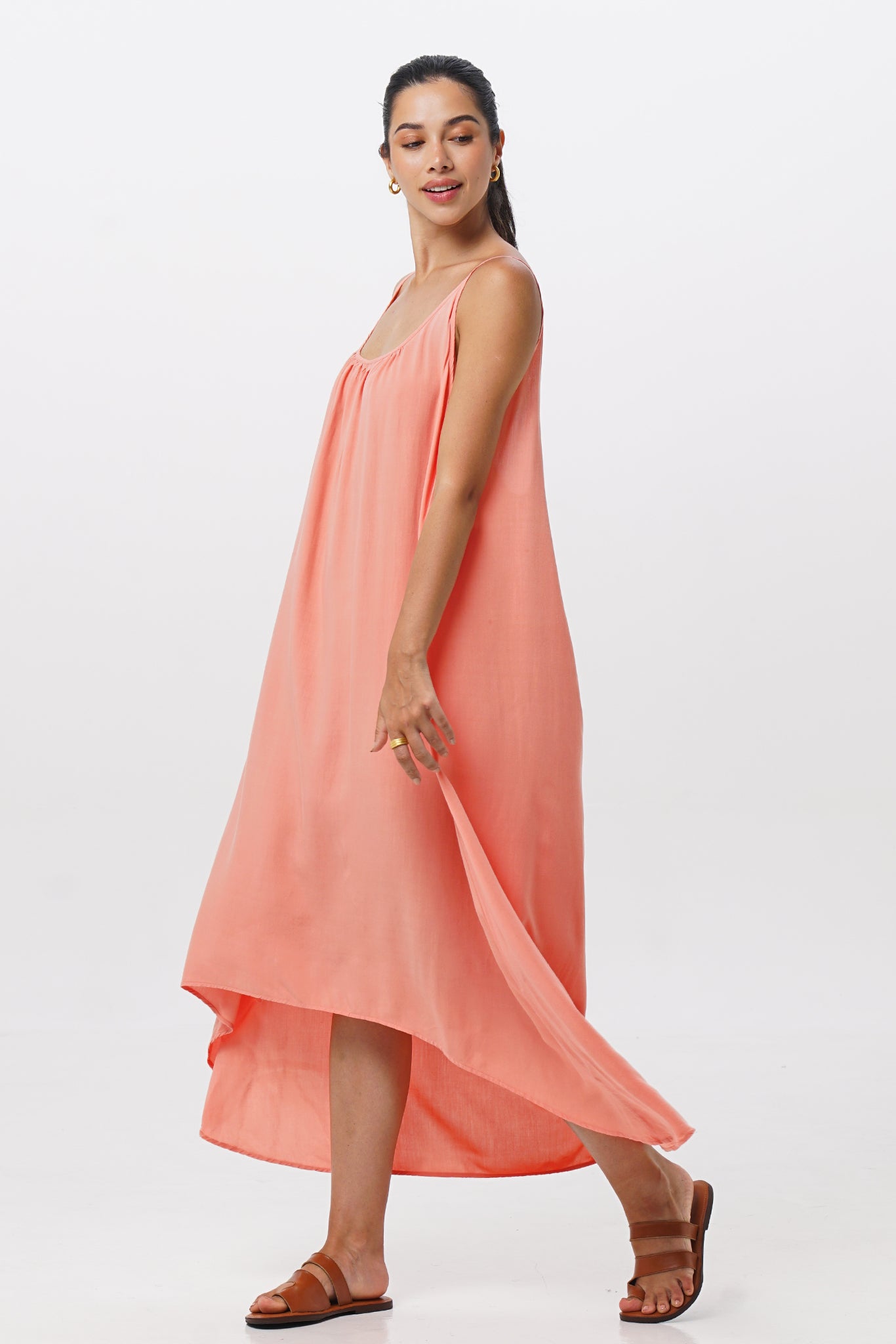 Side profile of the Mala Lowback Maxi Dress Rosa showing its cut and natural movement