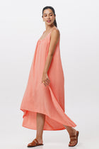 Side profile of the Mala Lowback Maxi Dress Rosa showing its cut and natural movement