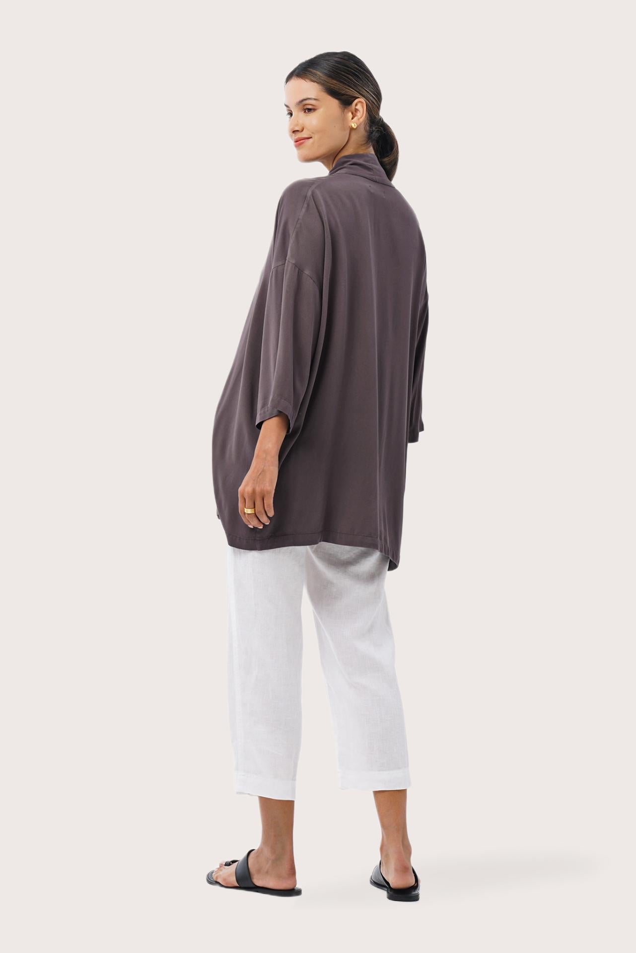 Back view of the Maluku Outerwear Ash highlighting the garment shape and drape