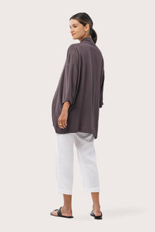 Back view of the Maluku Outerwear Ash highlighting the garment shape and drape