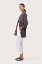 Side profile of the Maluku Outerwear Ash showing its cut and natural movement
