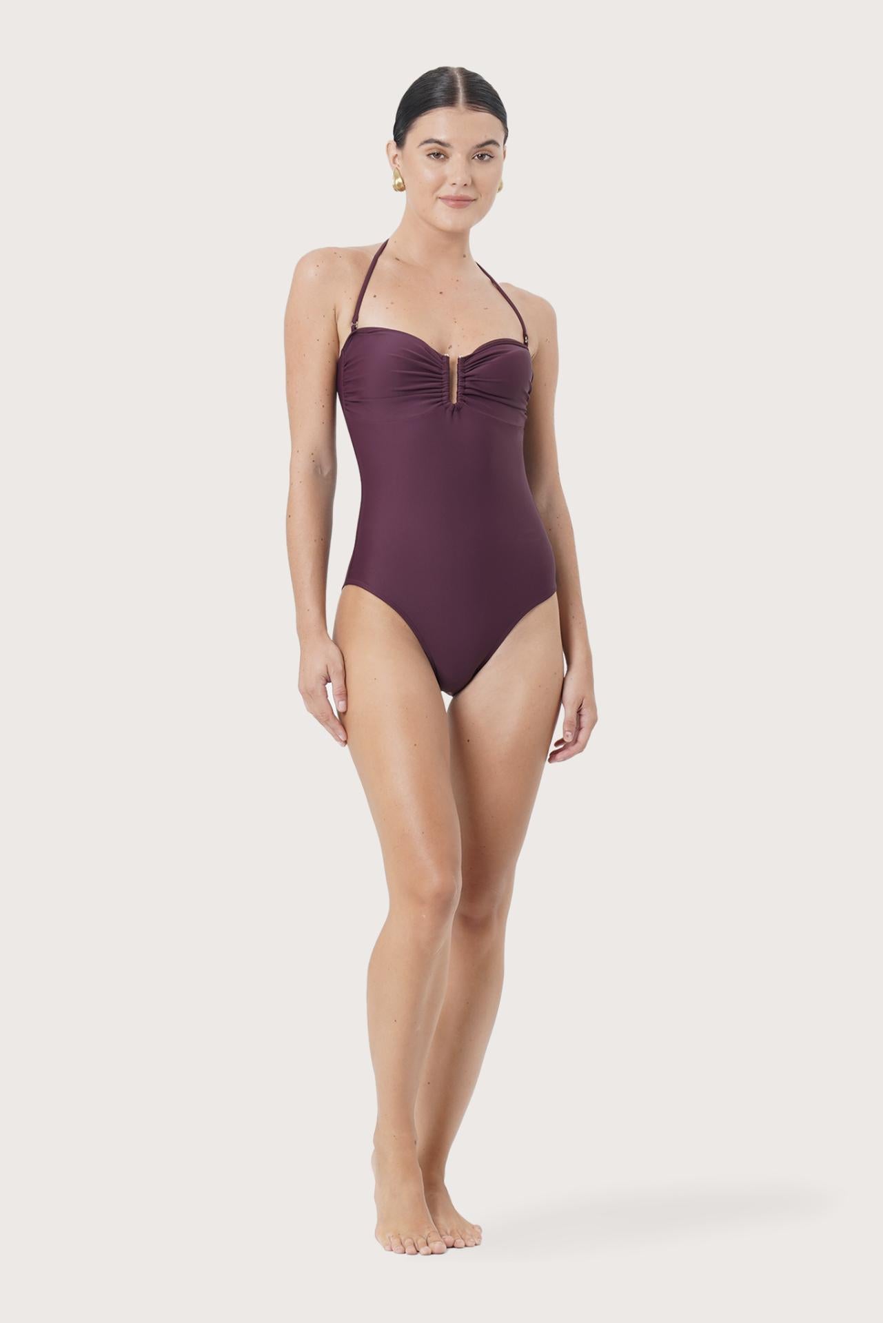 Model wearing Mara One Piece Swimsuit styled for luxury beachwear