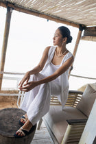 Women's white linen vest featuring a tailored sleeveless silhouette with breathable natural linen for elegant resort wear and effortless summer styling by By the Sea Bali