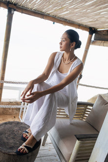 Women's white linen vest featuring a tailored sleeveless silhouette with breathable natural linen for elegant resort wear and effortless summer styling by By the Sea Bali