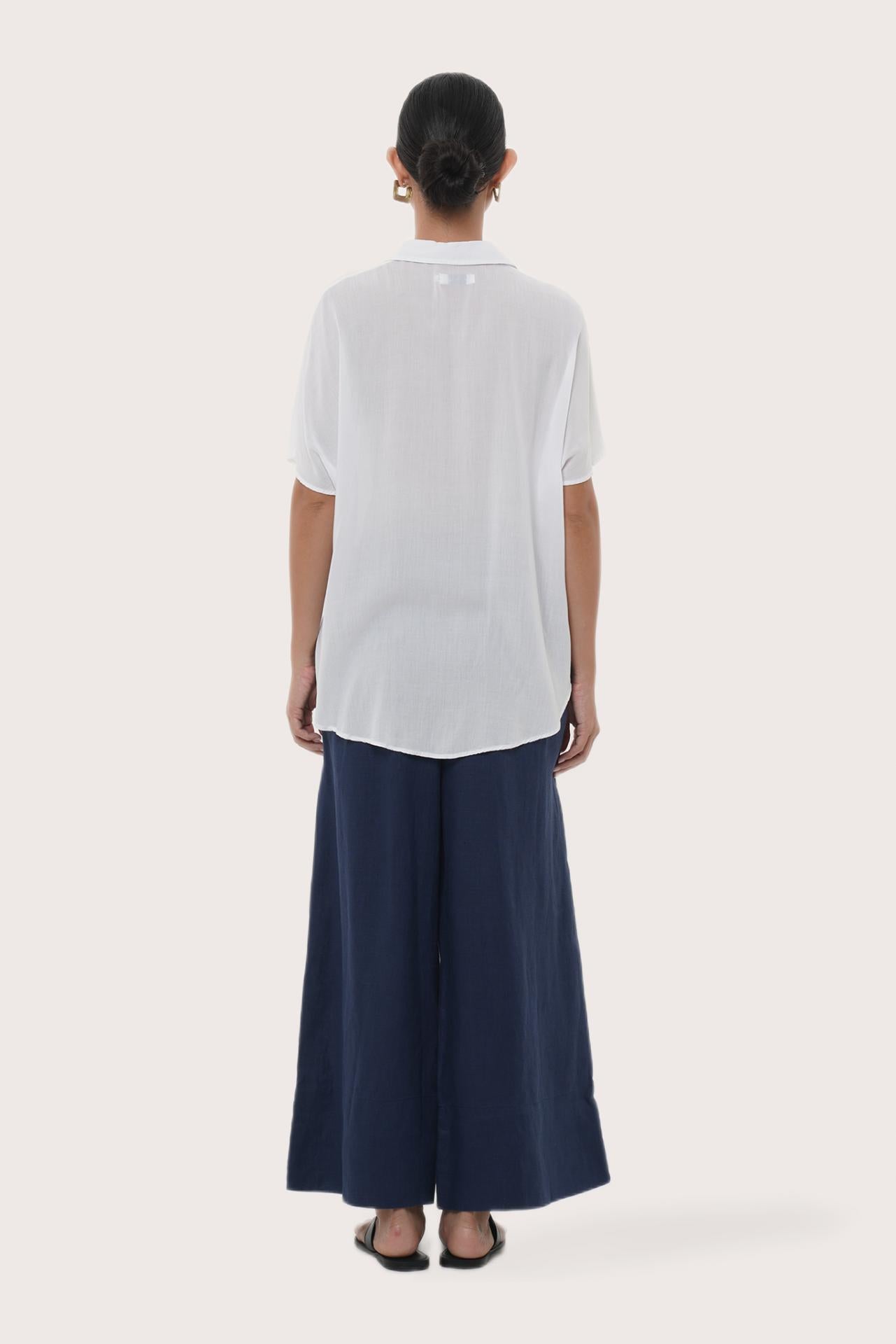 Back view of the Marina Linen Shirt White highlighting the garment shape and drape.
