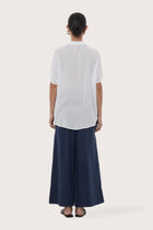Back view of the Marina Linen Shirt White highlighting the garment shape and drape.

