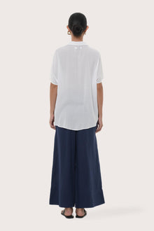 Back view of the Marina Linen Shirt White highlighting the garment shape and drape.
