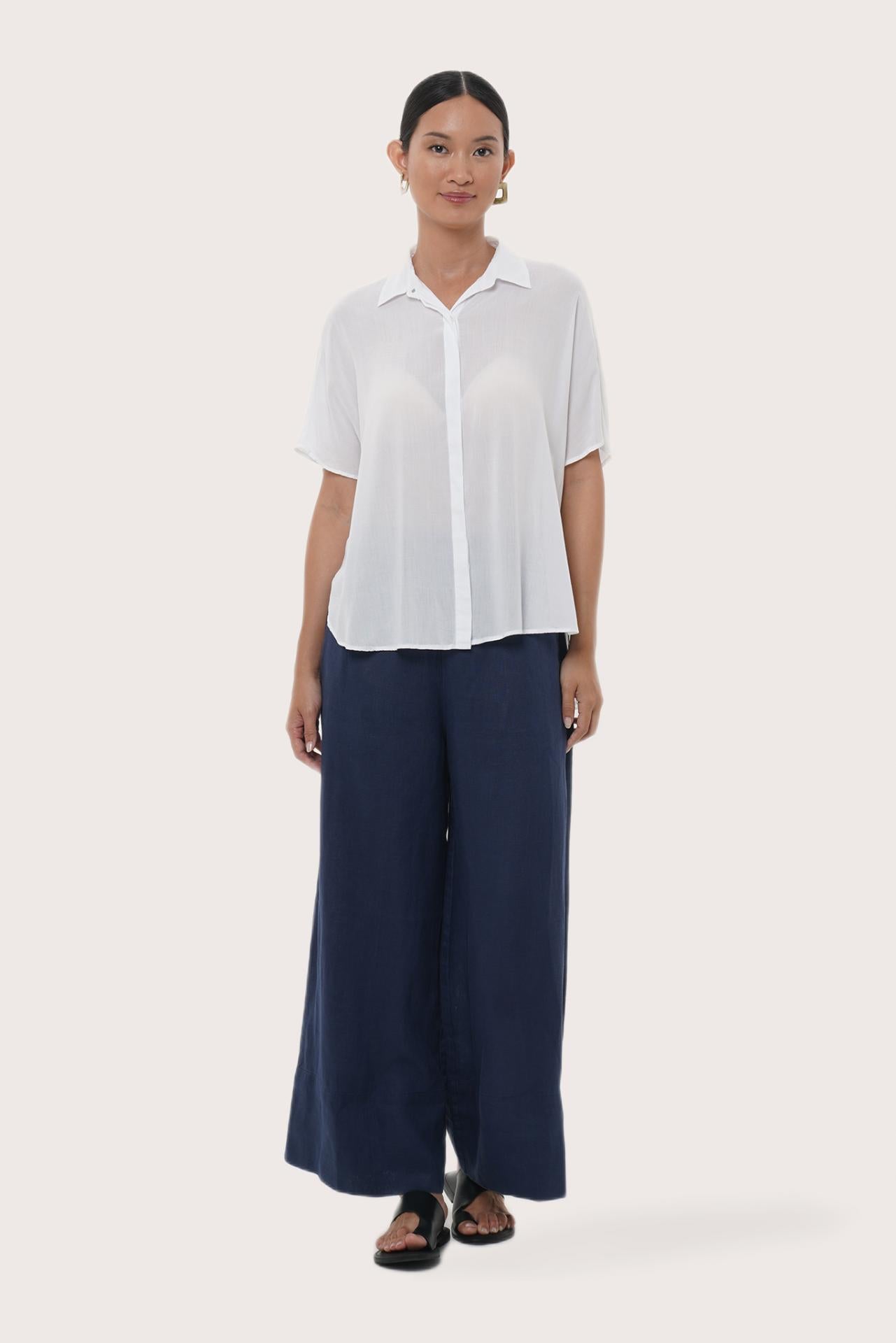 Woman wearing the Marina Linen Shirt White designed for effortless resortwear and tropical living by By The Sea Bali.