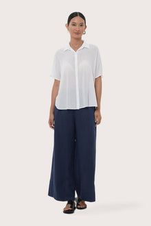 Woman wearing the Marina Linen Shirt White designed for effortless resortwear and tropical living by By The Sea Bali.