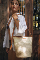 Luxury resort styling featuring the Marine Bag Light Brown in a tropical coastal setting