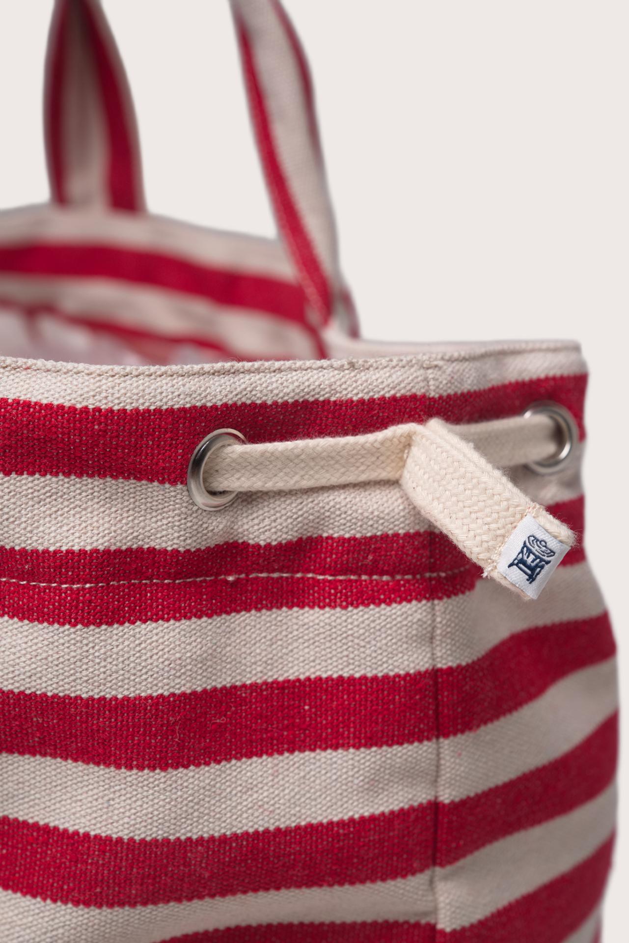 Angled view of the Marmara Stripe Tote Bag Stripes emphasizing its contemporary striped pattern and resort elegance