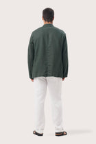 Back view of the dark green linen jacket with a relaxed and contemporary silhouette
