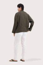 Back view of the dark green linen jacket with a relaxed and contemporary silhouette