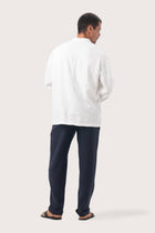 Back view of the natural white linen jacket with a relaxed and contemporary silhouette