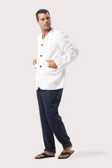 Side profile of the natural white linen jacket showcasing its comfortable fit and effortless drape