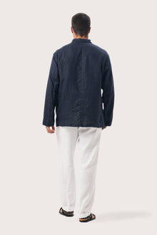 Back view of the navy blue linen jacket with a relaxed and contemporary silhouette