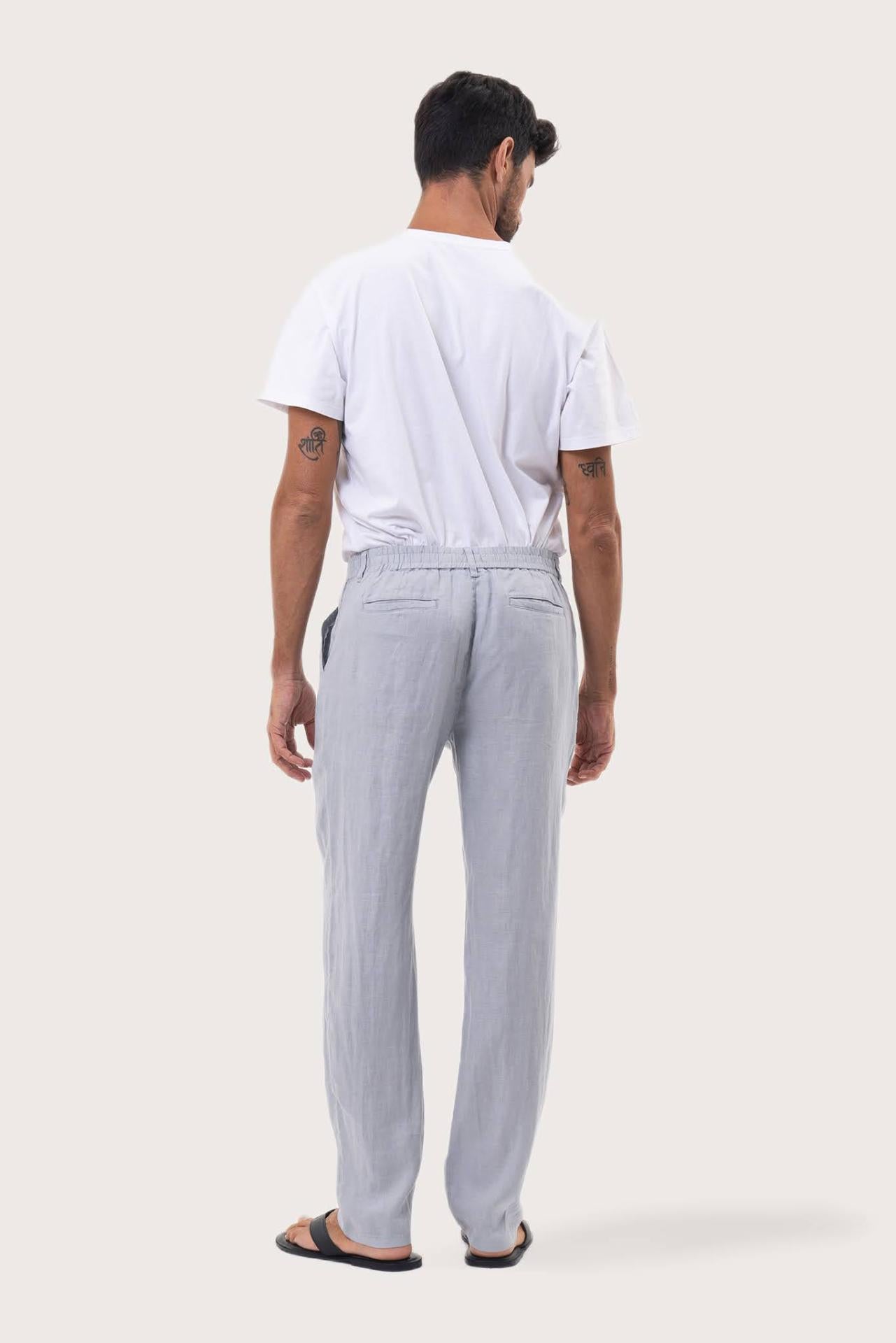 Back view of the Light Blue Maury Linen Long Pant showcasing its slit pockets and belt loops by By The Sea Bali