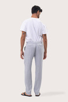Back view of the Light Blue Maury Linen Long Pant showcasing its slit pockets and belt loops by By The Sea Bali