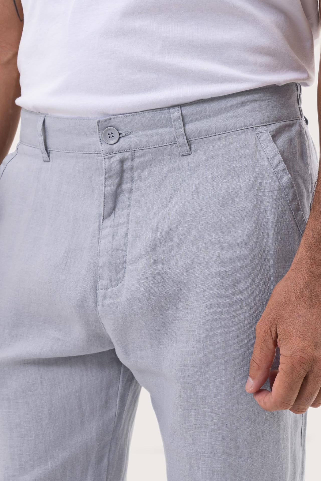 Close-up detail of the Maury Linen Long Pant in Light Blue highlighting the shell-button closure by By The Sea Bali