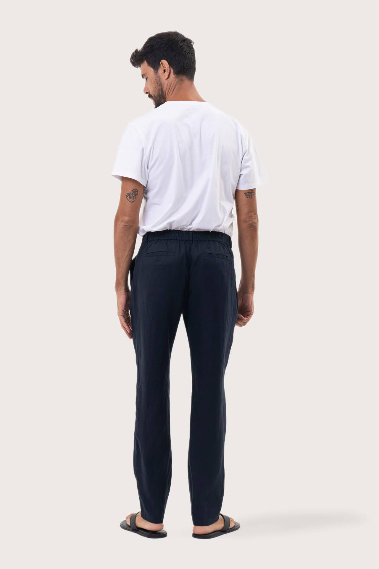 Back view of the Navy Maury Linen Long Pant showcasing its slit pockets and belt loops by By The Sea Bali