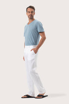 Side profile of the Maury Linen Long Pant in White by By The Sea Bali, tailored in pure linen