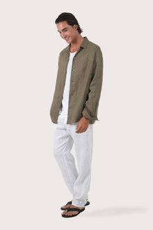 Side profile of the brown linen jacket showcasing its comfortable fit and effortless drape