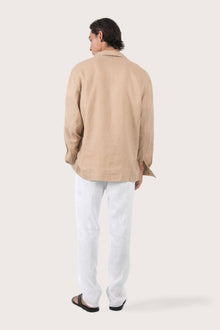 Back view of the creme linen jacket with a relaxed and contemporary silhouette