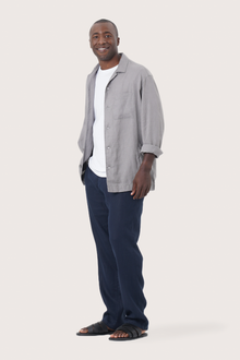Side profile of the grey linen jacket showcasing its comfortable fit and effortless drape