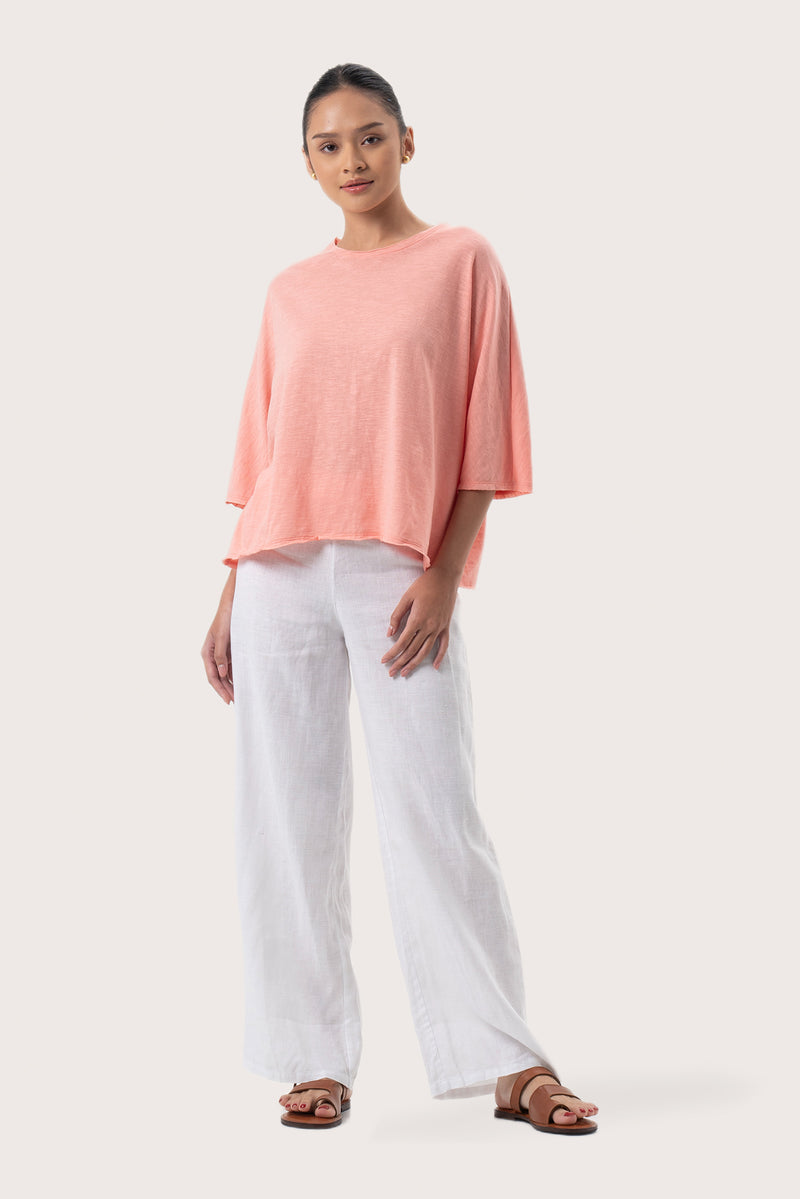 Woman wearing the Mawa Cotton T-Shirt Pink designed for effortless resortwear and tropical living by By The Sea Bali
