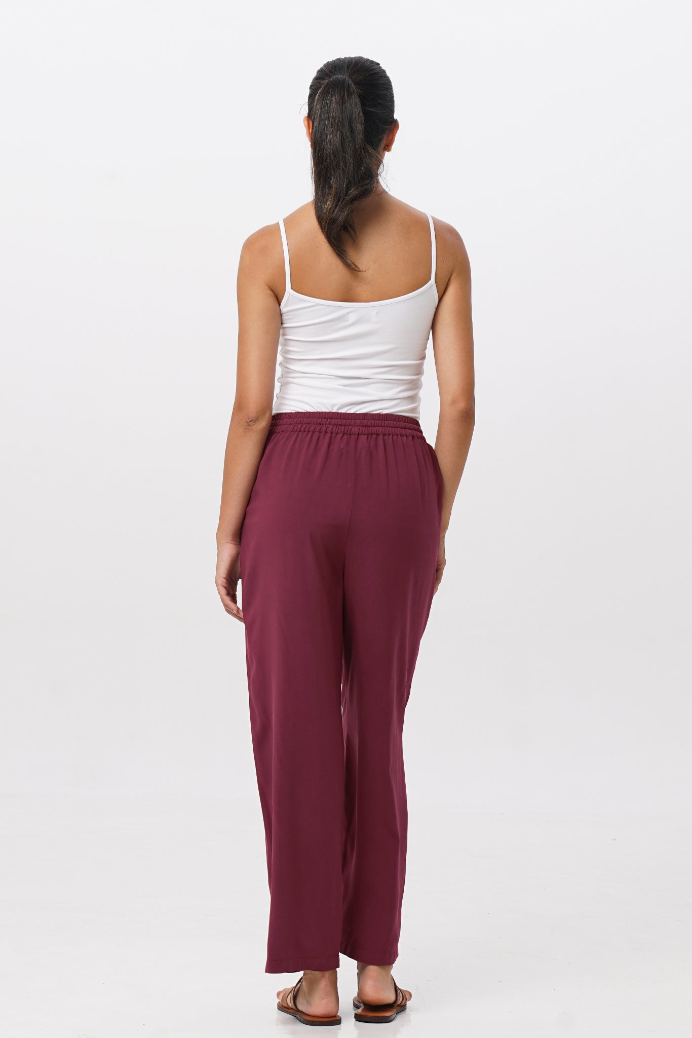 Back view of the Maya Drawstring Pants Brick highlighting the garment shape and drape.