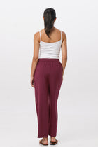 Back view of the Maya Drawstring Pants Brick highlighting the garment shape and drape.
