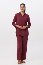 Woman wearing the Maya Drawstring Pants Brick combined with matching color shirt