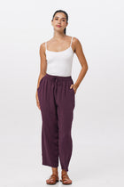 Woman wearing the Maya Drawstring Pants Dark Purple designed for effortless resortwear and tropical living by By The Sea Bali.