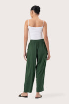 Back view of the Maya Drawstring Pants Forest Green highlighting the garment shape and drape.