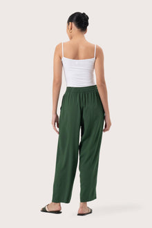 Back view of the Maya Drawstring Pants Forest Green highlighting the garment shape and drape.