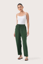 Woman wearing the Maya Drawstring Pants Forest Green designed for effortless resortwear and tropical living by By The Sea Bali.