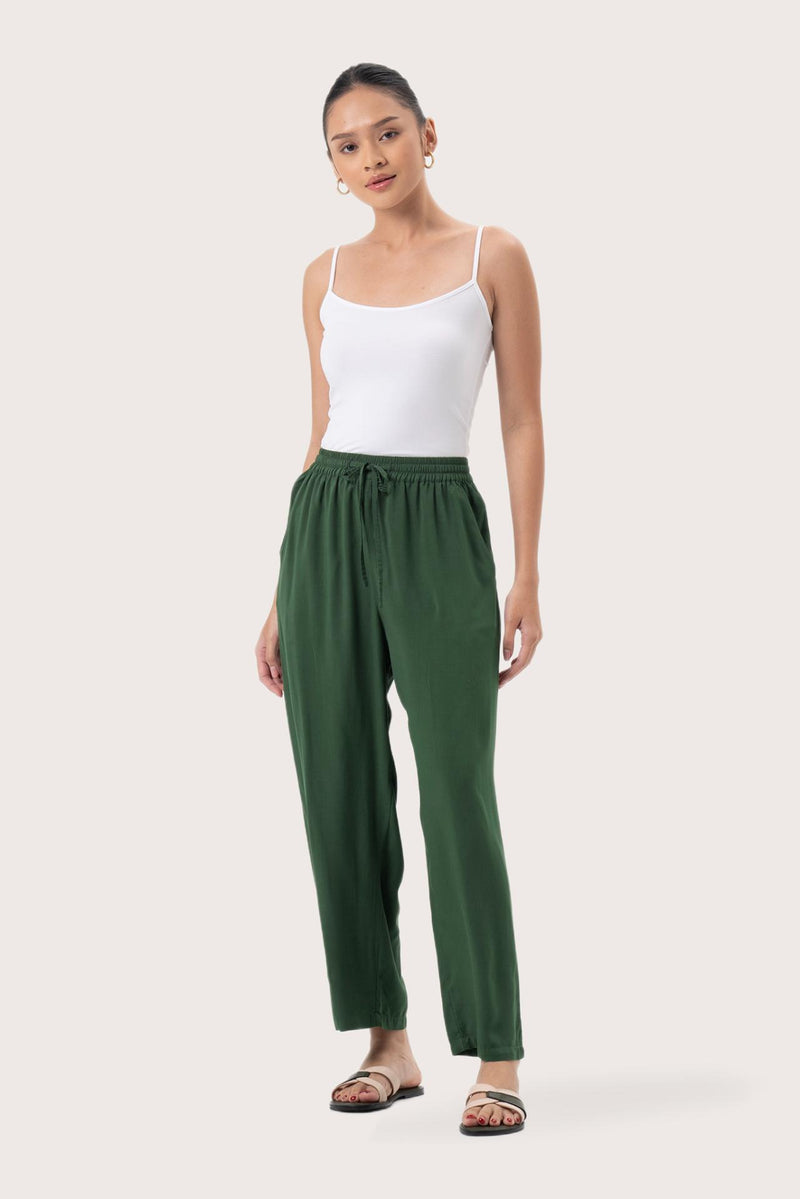 Woman wearing the Maya Drawstring Pants Forest Green designed for effortless resortwear and tropical living by By The Sea Bali.