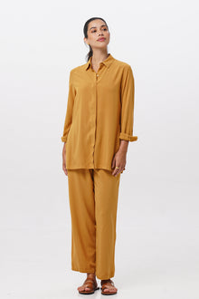 Woman wearing the Maya Drawstring Pants Mustrad combined with matching color shirt