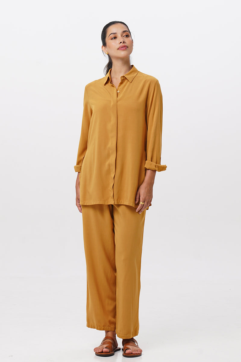 Woman wearing the Maya Drawstring Pants Mustrad combined with matching color shirt