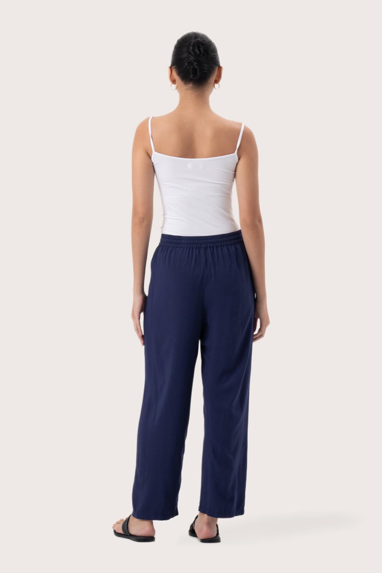 Back view of the Maya Drawstring Pants Navy highlighting the garment shape and drape.