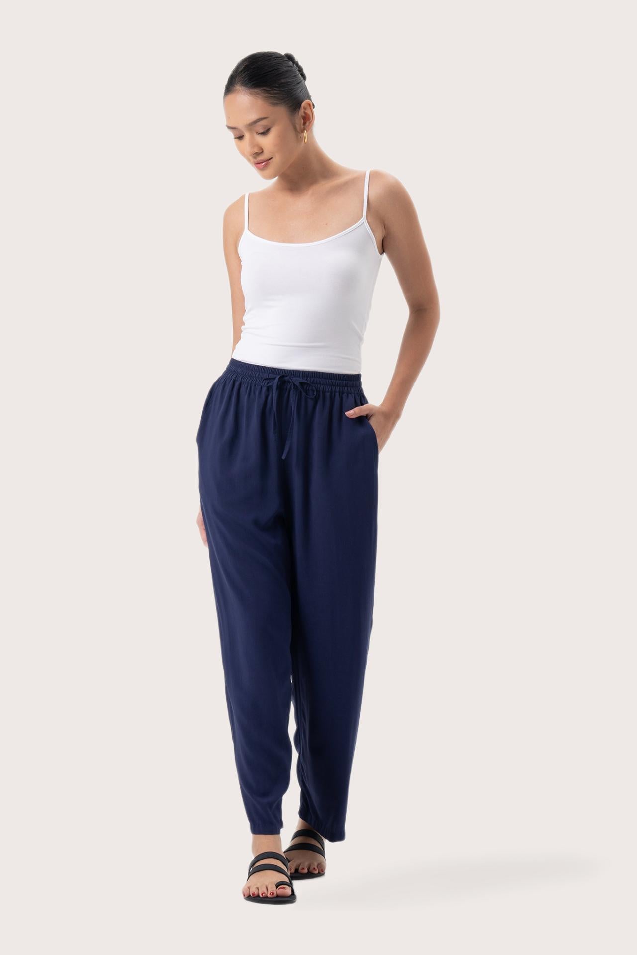 Woman wearing the Maya Drawstring Pants Navy designed for effortless resortwear and tropical living by By The Sea Bali.