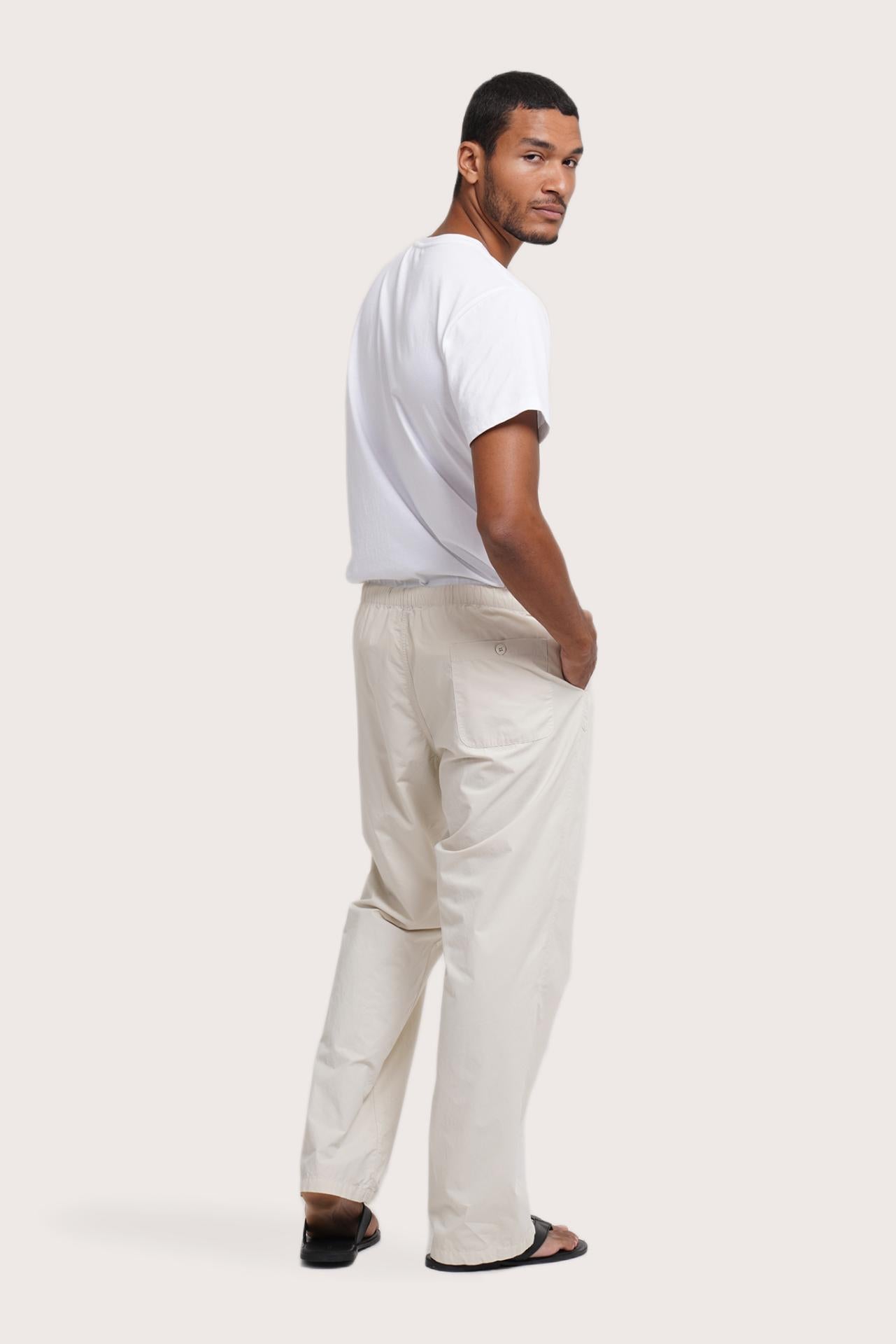 Back view of the Creme Cotton Relax Drawstring Pant showcasing its welt pocket detail by By The Sea Bali