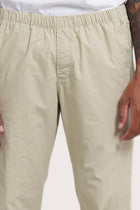 Close-up detail of the Light Grey Green Cotton Relax Pant featuring the dove-button drawstring waist by By The Sea Bali