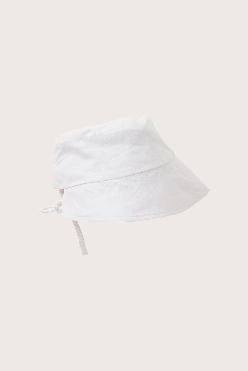 Side view of the Miki Linen Half Brim Hat Off White highlighting its soft linen construction and distinctive half-brim design