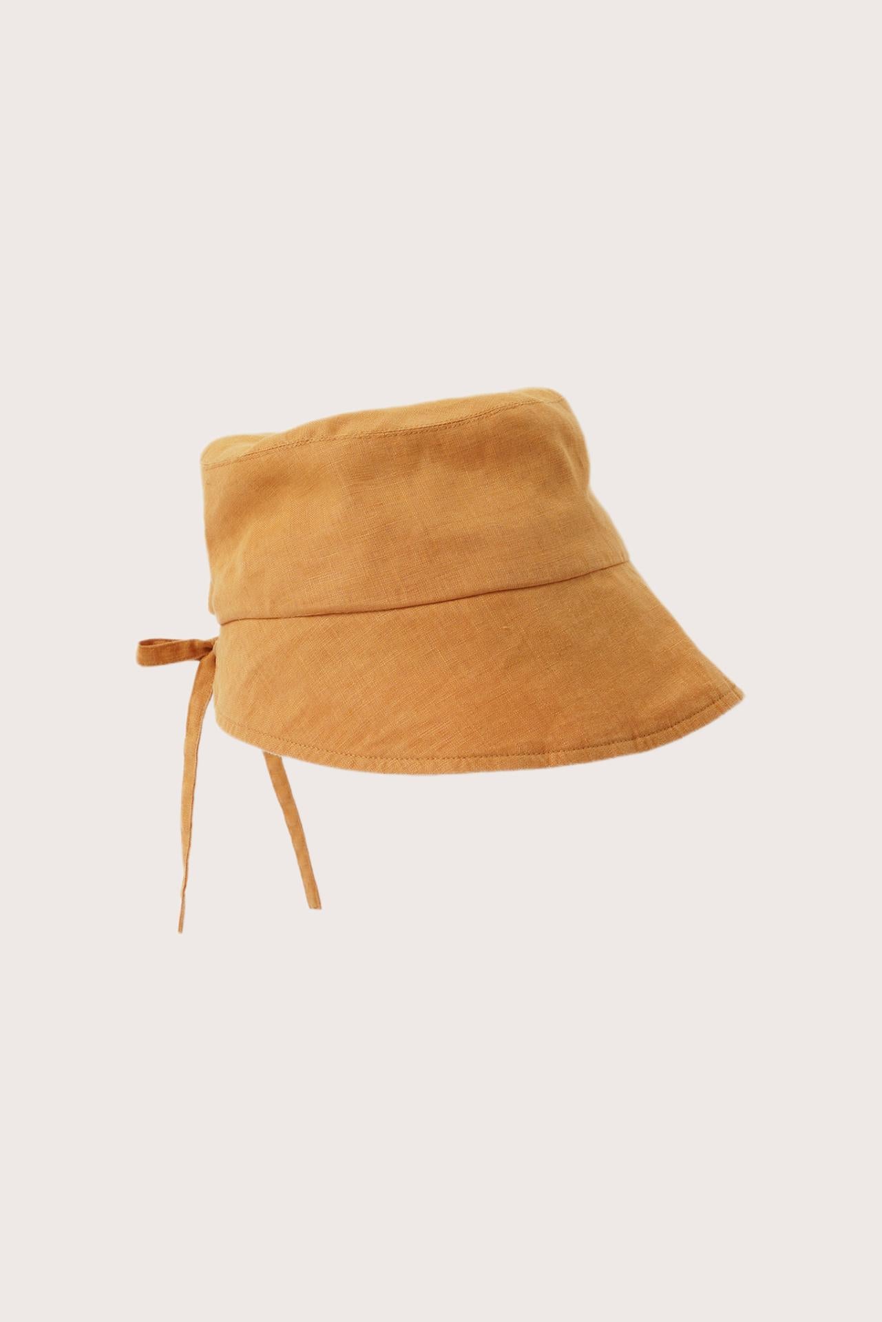 Side view of the Miki Linen Half Brim Hat Tangerine highlighting its soft linen construction and half-brim design