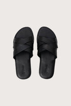 Milos sandal in nero shown in a global view highlighting its full silhouette and refined resort design